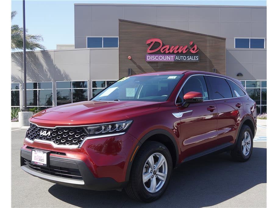 2023 Kia Sorento LX in Passion Red — front three-quarter view