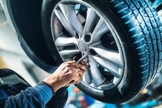 image of someone servicing a tire